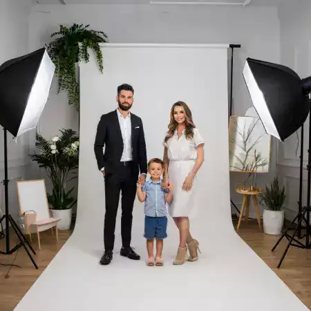 Photographer adjusting camera settings for a studio shoot
